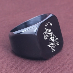 Macro shot of 18mm black polished stainless steel signet ring with laser-engraved tiger