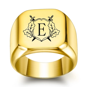 Macro view of 18K gold square signet ring featuring engraved shield and letter E crest