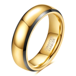 Macro detail of polished gold and black tungsten carbide ring showing material engraving