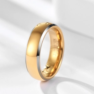 Close-up of two-tone tungsten carbide ring with polished gold surface and silver edges