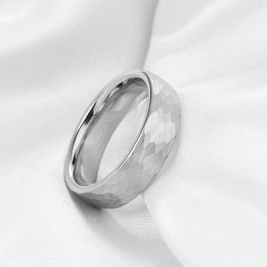 Macro detail of silver hammered finish stainless steel ring with polished inner surface