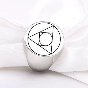 Close-up of silver stainless steel signet ring with geometric alchemy symbol engraving