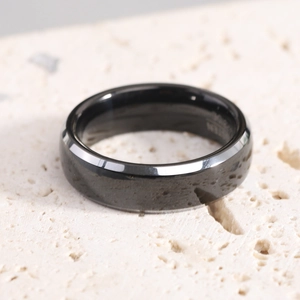 Macro shot of 8mm black tungsten carbide ring with a polished bevel edge and inner engraving