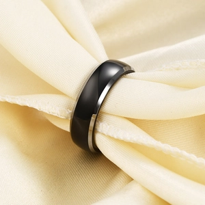 Polished black stainless steel dome ring displayed on premium beige silk fabric background
