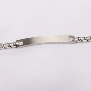Detailed macro view of silver brushed rectangular metal bar on a box chain bracelet