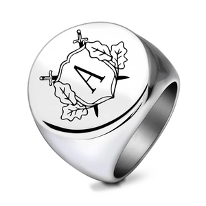 Detail of laser engraved signet ring featuring a heraldic shield with letter A and swords