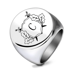 Detail of silver stainless steel signet ring with engraved coat of arms and letter C