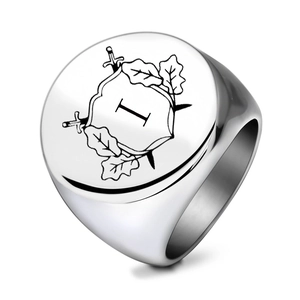 Macro shot of silver stainless steel signet ring with engraved heraldic swords and letter I