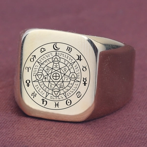 Detailed macro view of gold square signet ring featuring engraved astrology zodiac map