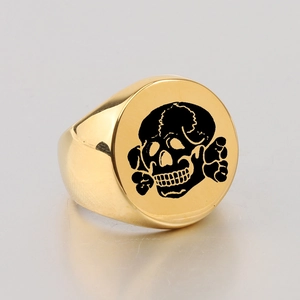 Detailed macro view of the gold-plated round skull signet ring with laser engraving