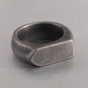 Macro side view of a heavy rectangular signet ring in vintage dark grey finish