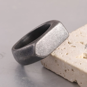Vintage style geometric stainless steel ring with matte finish on textured stone