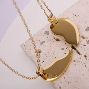 Close-up of gold stainless steel puzzle heart pendants with high polished finish