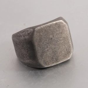 Macro shot of vintage silver signet ring with distressed industrial brushed texture