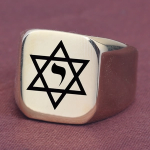 Detailed close-up of gold stainless steel signet ring with engraved Star of David symbol