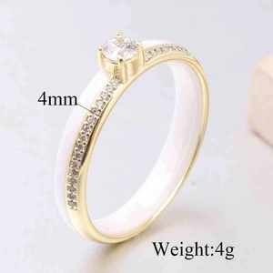 Detailed macro view of 4mm white ceramic ring with gold plating and sparkling zircon stones