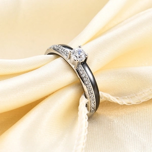 Close-up of a 4mm black ceramic ring with silver plating and sparkling zircon stones