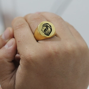 Polished gold stainless steel signet ring for men featuring a laser-engraved lion head