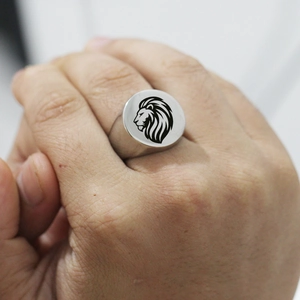 Polished stainless steel signet ring for men featuring a black laser engraved lion head