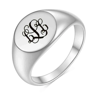 Detalle de anillo de sello de acero inoxidable plateado con monograma de letra cursiva