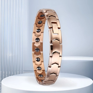 Detail of rose gold magnetic therapy bracelet with arrow-shaped links on a stand