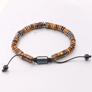 Macro detail of adjustable tiger eye bead bracelet with woven cord and sliding knot