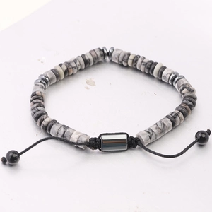 Detail of adjustable braided bracelet with gray cylinder stone beads and silver spacers
