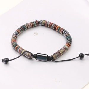Macro shot of tiger eye stone beads on a black woven adjustable bracelet