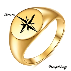Detail view of 12mm gold stainless steel signet ring with engraved black star pattern