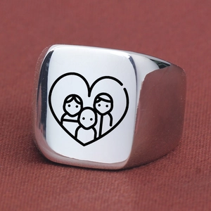 Detailed close-up of a square signet ring with a laser-engraved heart family portrait