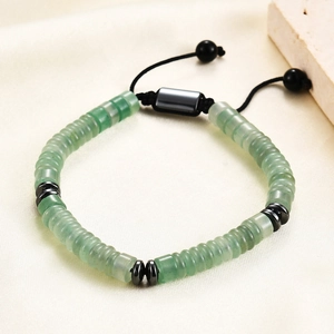 Macro view of green natural stone wheel beads with adjustable black braided rope bracelet