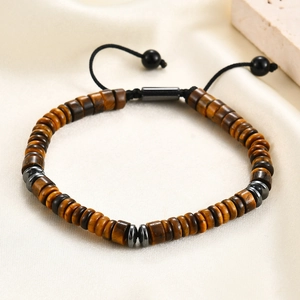 Macro view of woven tiger eye stone beads and adjustable pull string on silk