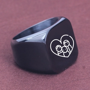 Macro shot of polished black square signet ring featuring a laser-engraved family heart