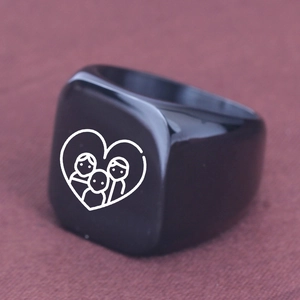 Macro shot of family heart laser engraving on matte black square signet ring