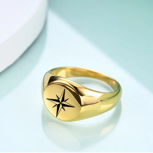 Close-up of a vintage 12mm gold stainless steel signet ring with an engraved star