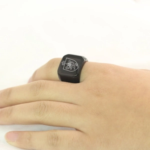 Polished black stainless steel signet ring with engraved royal lion and crown emblem