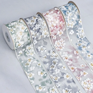 Close-up of sheer floral organza ribbons with gold foil cherry blossoms in four colors