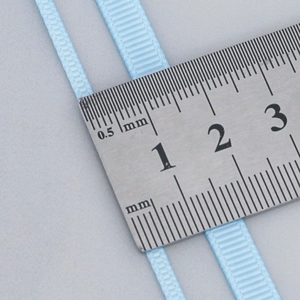 Light blue grosgrain ribbons in 3mm and 6mm widths shown with a ruler for size scale