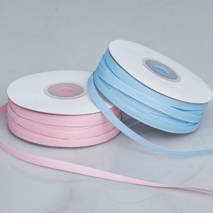 Detail of pink and light blue ribbed grosgrain ribbons showing fine horizontal textures