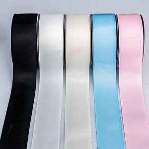 Detail view of 4cm grosgrain ribbon rolls in five pastel colors with ribbed texture