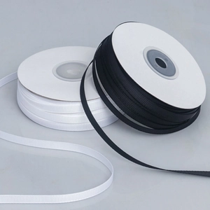Detail showing high density black and white polyester grosgrain ribbons with ribbed texture