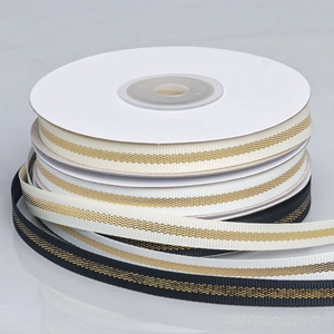 Glittering gold threaded ribbed ribbons in black and beige on rolls for DIY gift wrapping