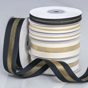 Detail of ribbed glitter ribbons in black and ivory with gold metallic center lines
