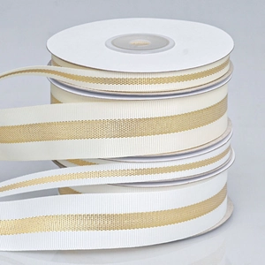 Rolls of cream and off-white ribbed ribbons with shiny gold stripes for DIY gift wrapping