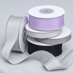 Stack of multi-color grosgrain ribbons with ribbed texture in various widths and neutral tones