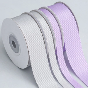 Macro view of white and light purple grosgrain ribbon with textured ribbed edges