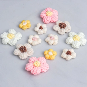 Macro shot of colorful milk cotton crochet puff flowers showing fine handmade yarn texture