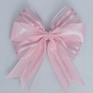 Pink ribbon bow made of satin and vertical striped organza for gift wrapping