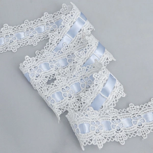 Detail of 4.5cm white hollow lace trim with light blue satin ribbon for DIY sewing