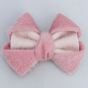 Detail view of a soft plush pink bow accessory for DIY hair clips and fashion crafts